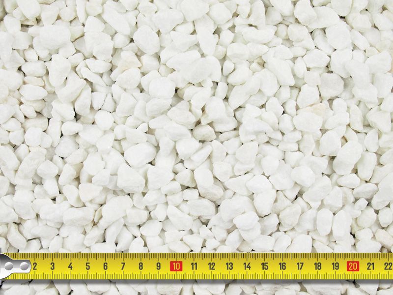 White decorative gravel stones with a measuring tape showing scale.