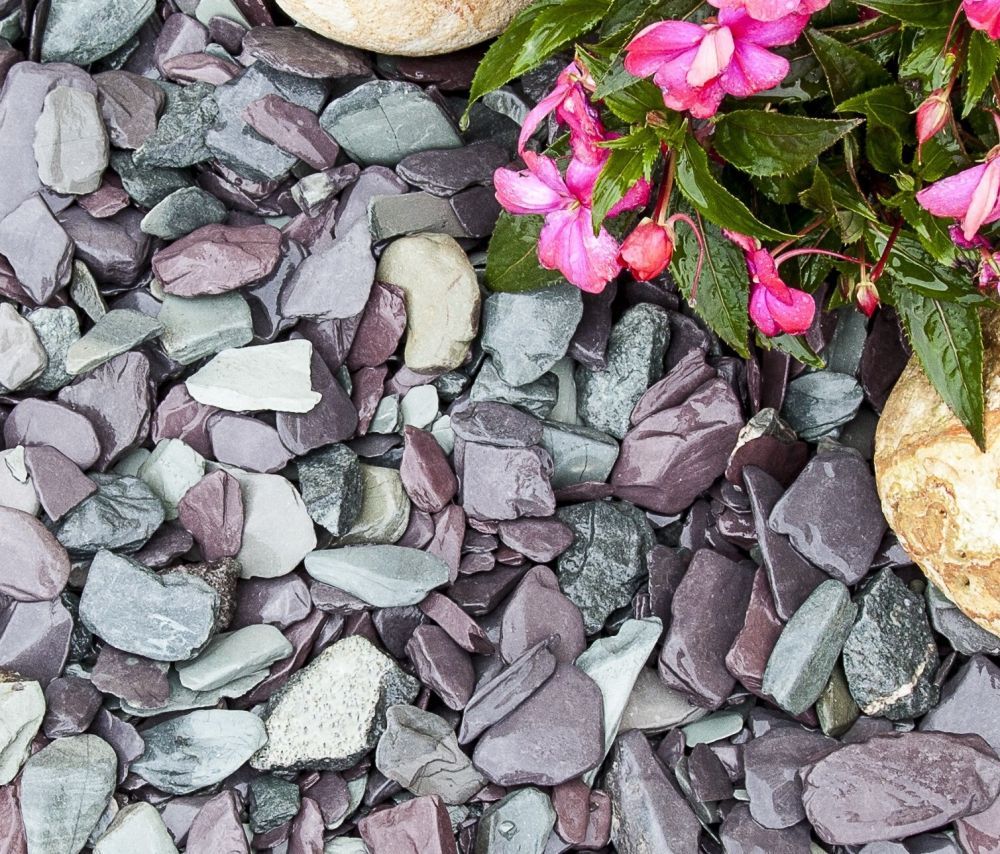 Close-up of Snowdonia tumbled stones in blue, plum, and green shades, with larger stones visible.