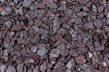 A close-up image of blue slate chippings with varying shades of blue and a textured surface.
