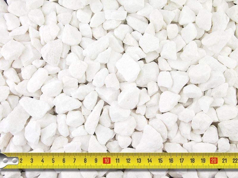 White decorative gravel stones with a measuring tape showing scale.