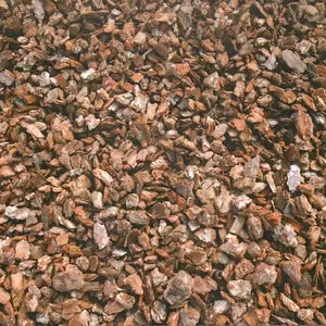 A close-up view of Premium Play Nuggets, which are brown pine bark mulch pieces.