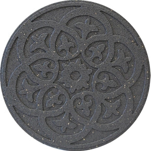 The image shows a round stone with an intricate, floral pattern