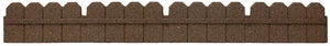 A section of a terracotta brown stone garden border with a scalloped top, typically used to edge flower beds or lawns.